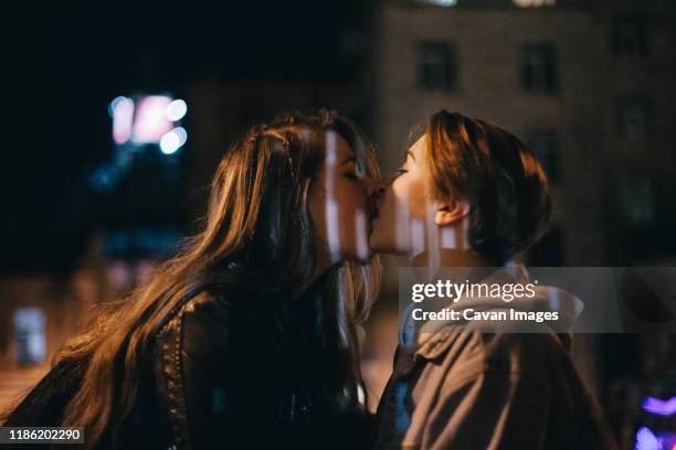 Passionate lesbian kissing Ace of spades anal plug